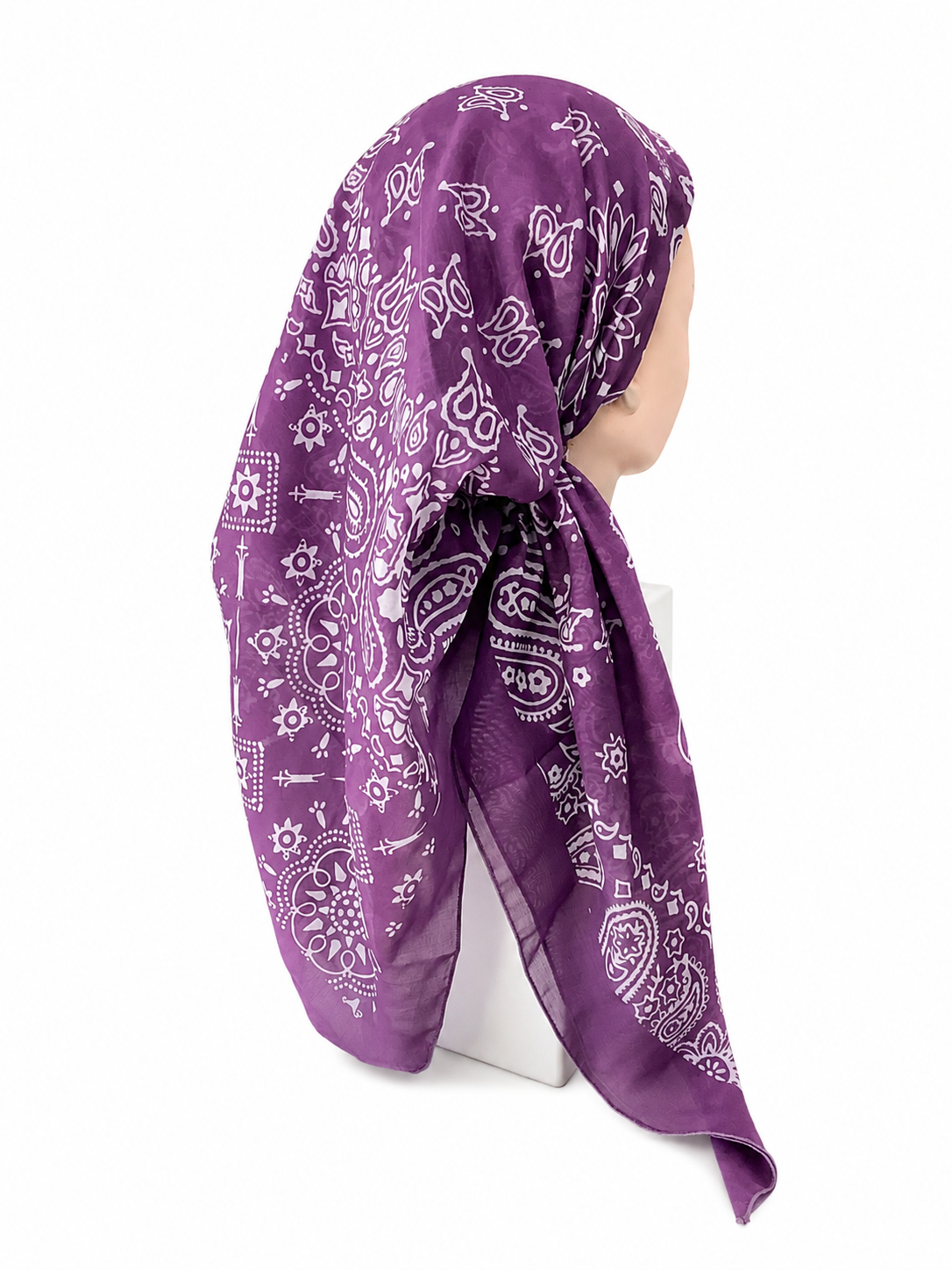 A purple bandana headscarf with a white paisley and floral print, styled on a mannequin head against a plain white background.