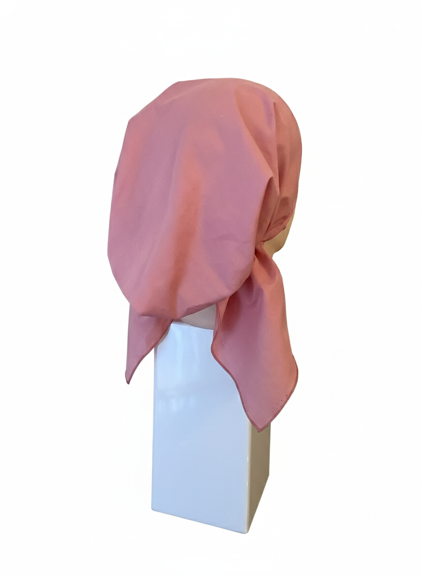 Pink short-tail pretied tichel on a mannequin head against a white background
