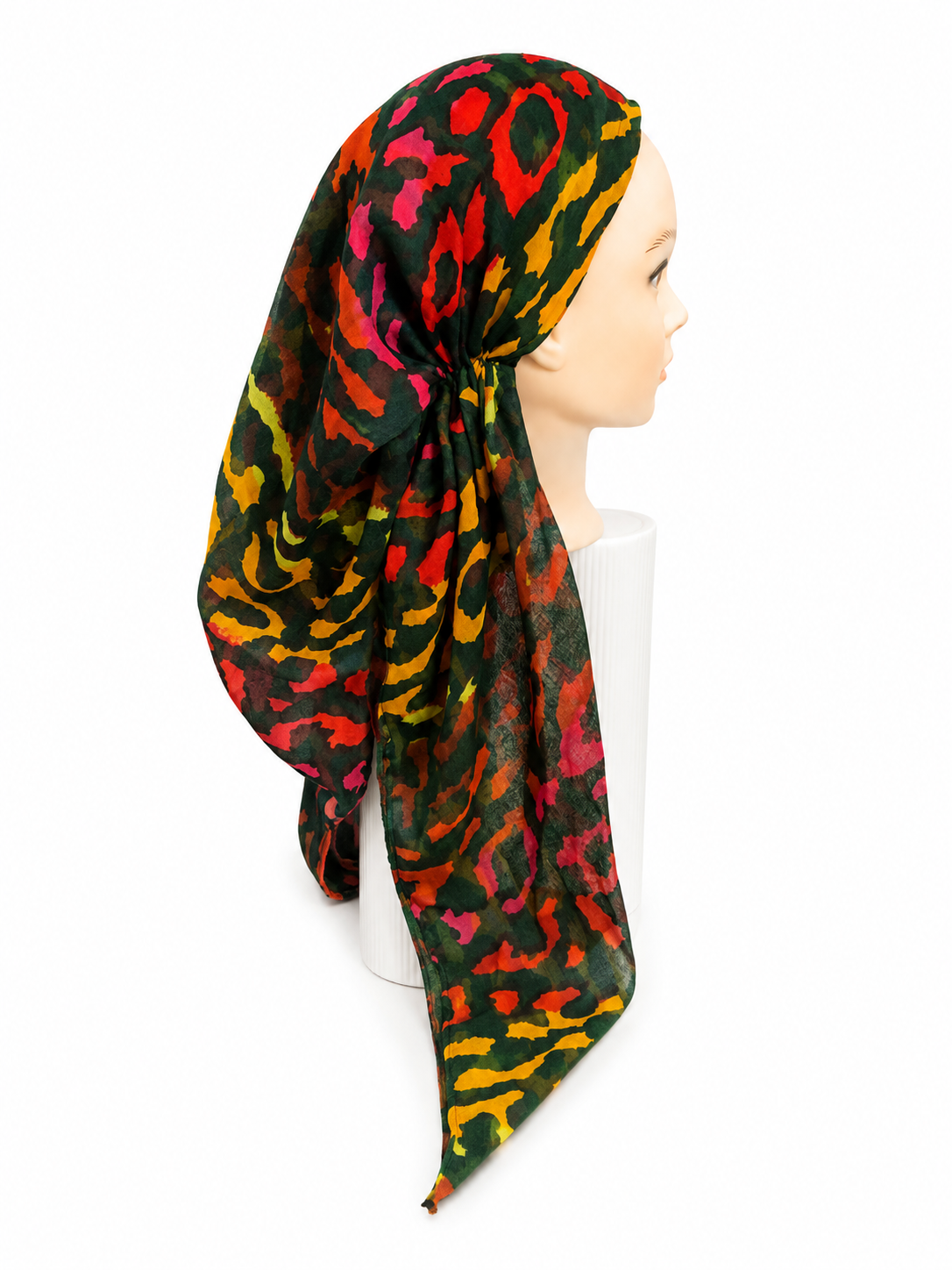 A multicolor leopard print headscarf draped on a mannequin head against a plain white background.