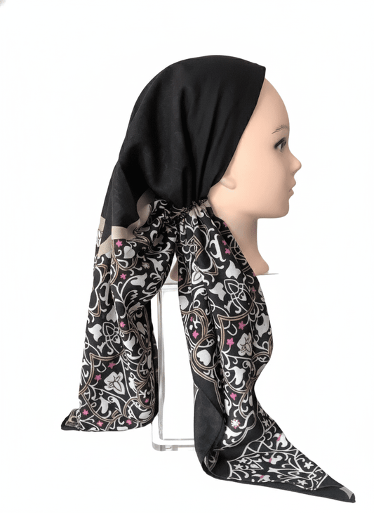 Luxury pretied tichel headscarf with black and floral patterned fabric on mannequin