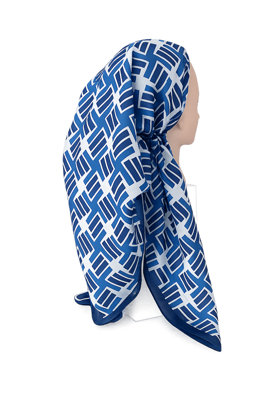 Blue and white patterned headscarf on a mannequin against a white background