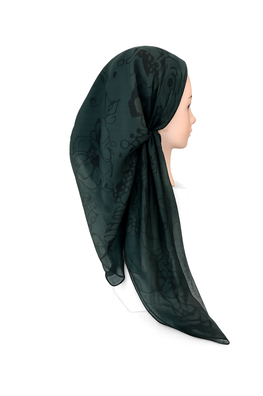 Dark green tichel with floral patterns on a white background