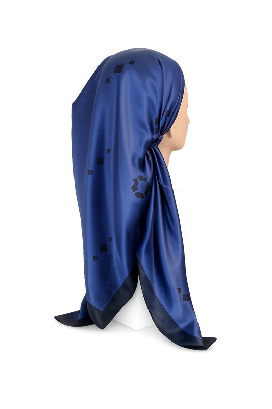 Blue pretied tichel with black patterns on a mannequin head against a white background