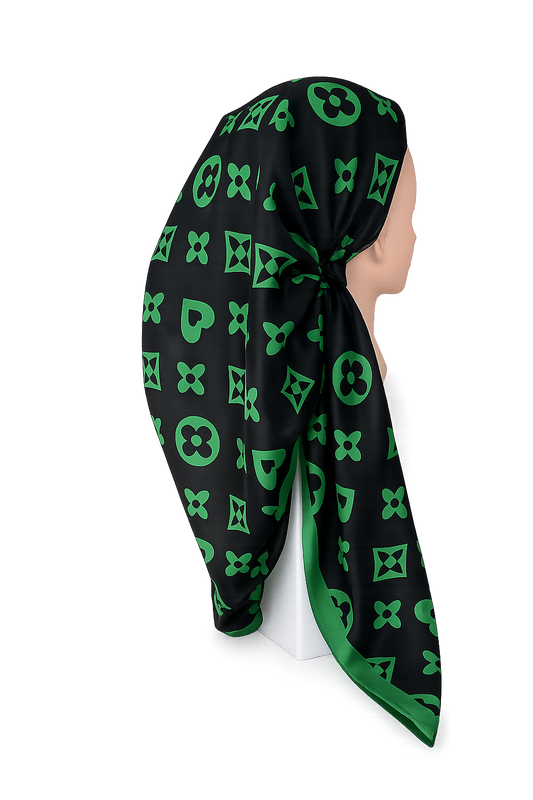 Black scarf with green geometric pattern draped over a mannequin head on a white background
