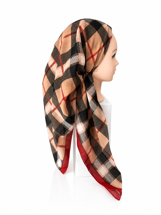 Plaid scarf on a mannequin head against a white background