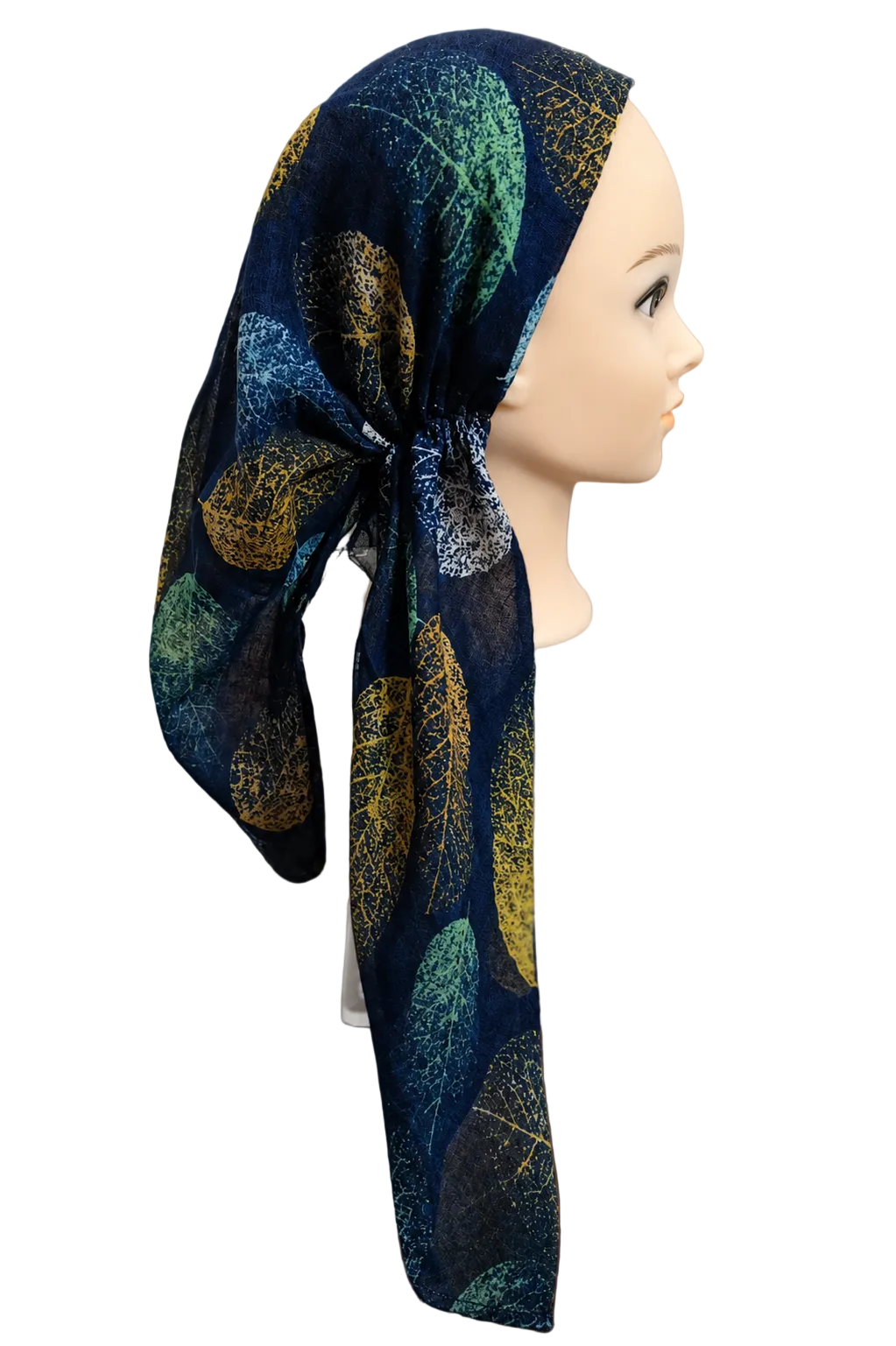 A dark navy blue headscarf with a metallic gold and teal abstract leaf pattern, styled on a mannequin head against a white background.