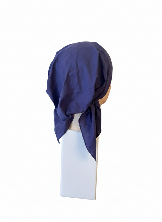 Navy blue tichel on a mannequin head against a white background