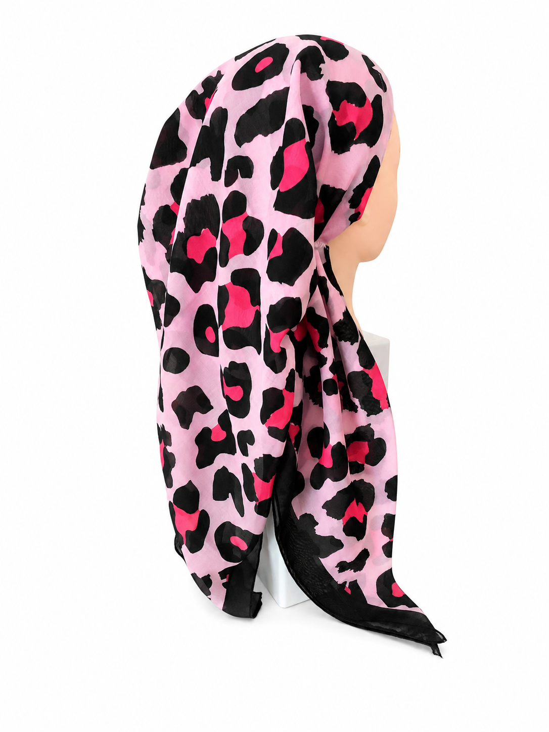 A PRETIED TICHEL with a black and hot pink leopard print pattern, draped on a mannequin head against a white background.