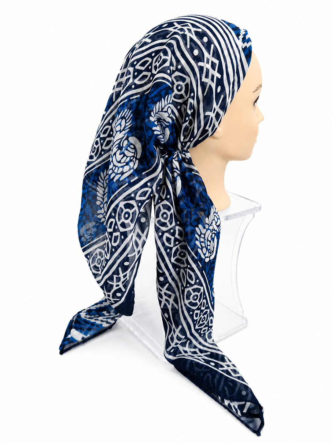 A navy blue and white patterned scarf styled on a mannequin head with a clear stand against a white background.