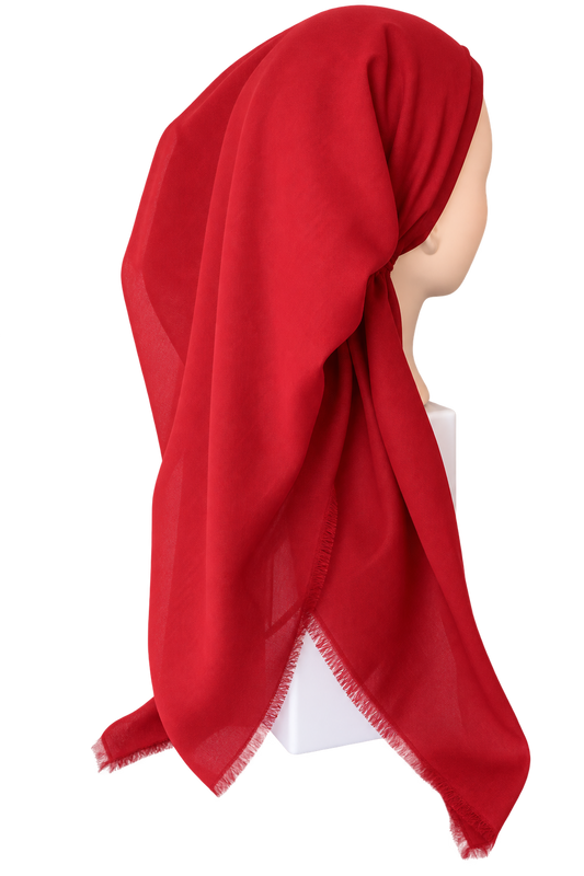 A bright red lightweight headscarf or hijab draped on a mannequin head against a plain white background.