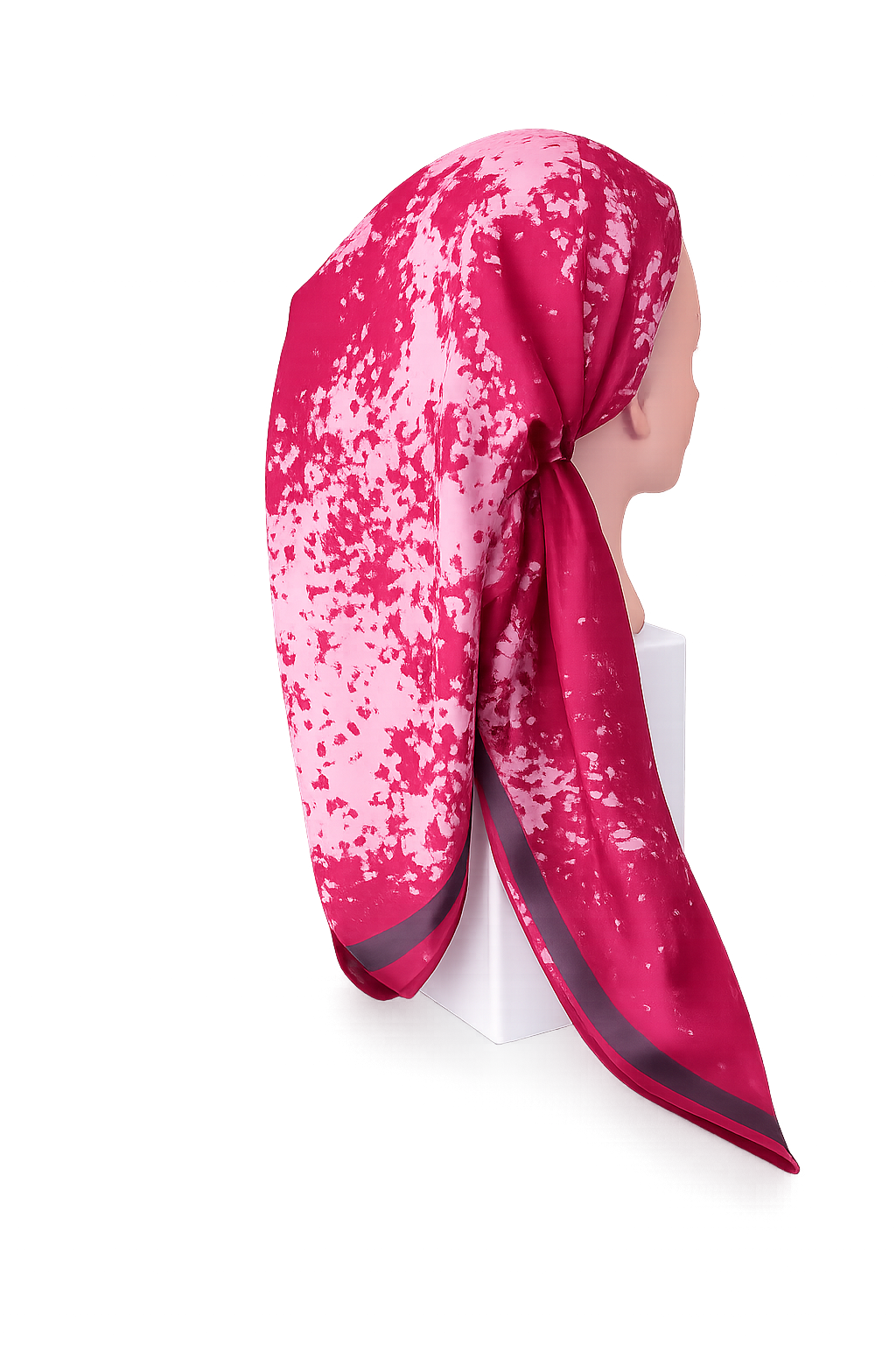 Pink and white patterned headscarf on a mannequin against a white background