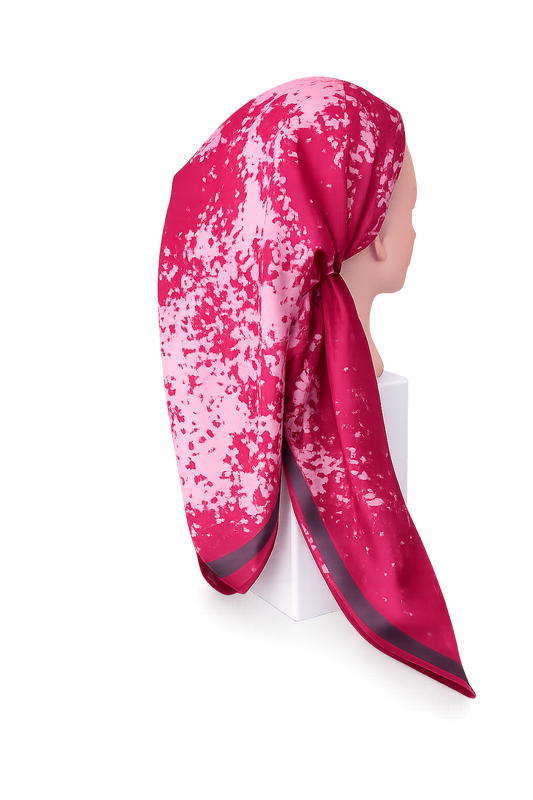 Pink and white patterned headscarf on a mannequin against a white background