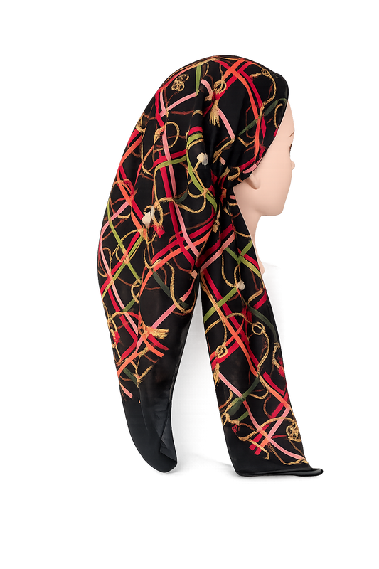 A black POLY-COTTON headscarf with a colorful interlocking chain link pattern in red, gold, and green, styled on a mannequin head against a white background.