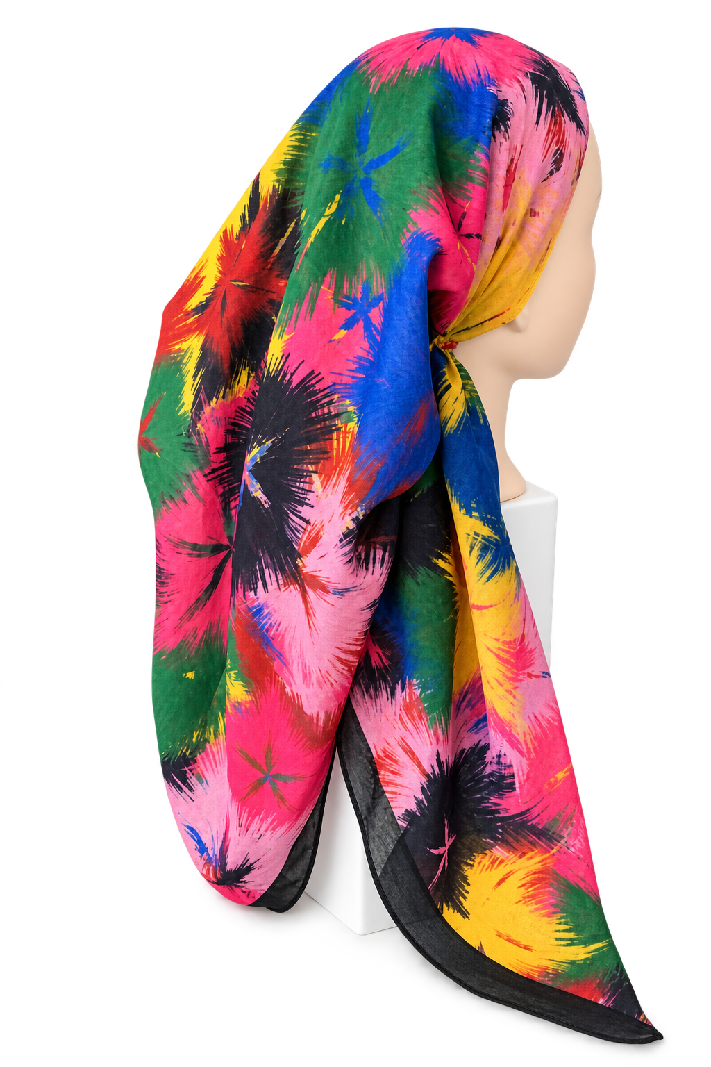 A multicolor scarf with a vibrant abstract floral or starburst pattern in pink, blue, green, yellow, and black, styled on a mannequin head against a white background.