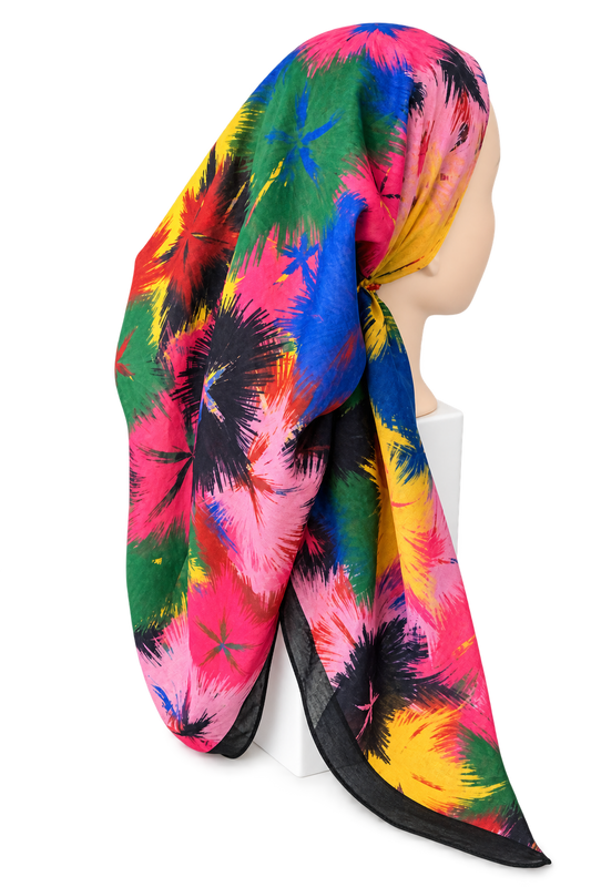 A multicolor scarf with a vibrant abstract floral or starburst pattern in pink, blue, green, yellow, and black, styled on a mannequin head against a white background.