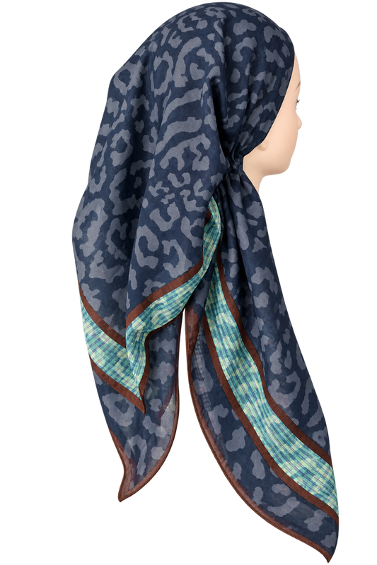 A navy blue pretied tichel with a gray leopard print pattern and a contrasting border featuring a mint green and white checkered pattern and thin brown trim, displayed on a mannequin head against a white background.