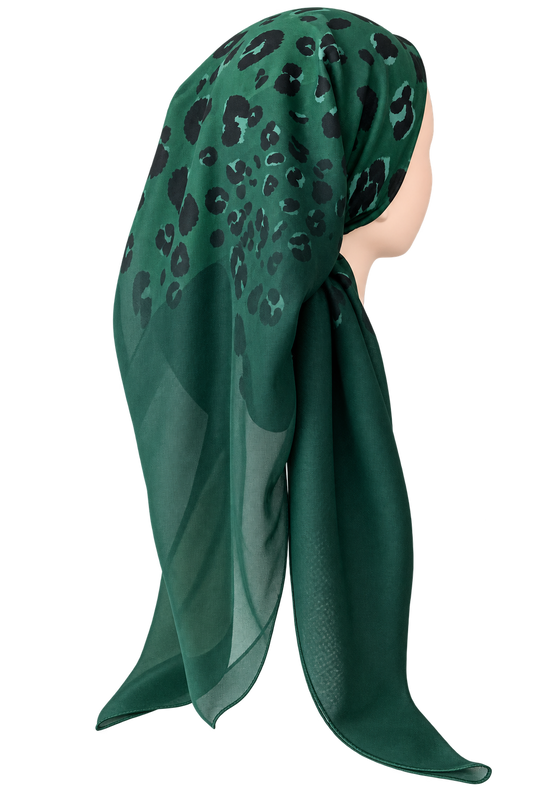 A dark green headscarf with a black leopard print pattern, styled on a mannequin head against a plain white background.