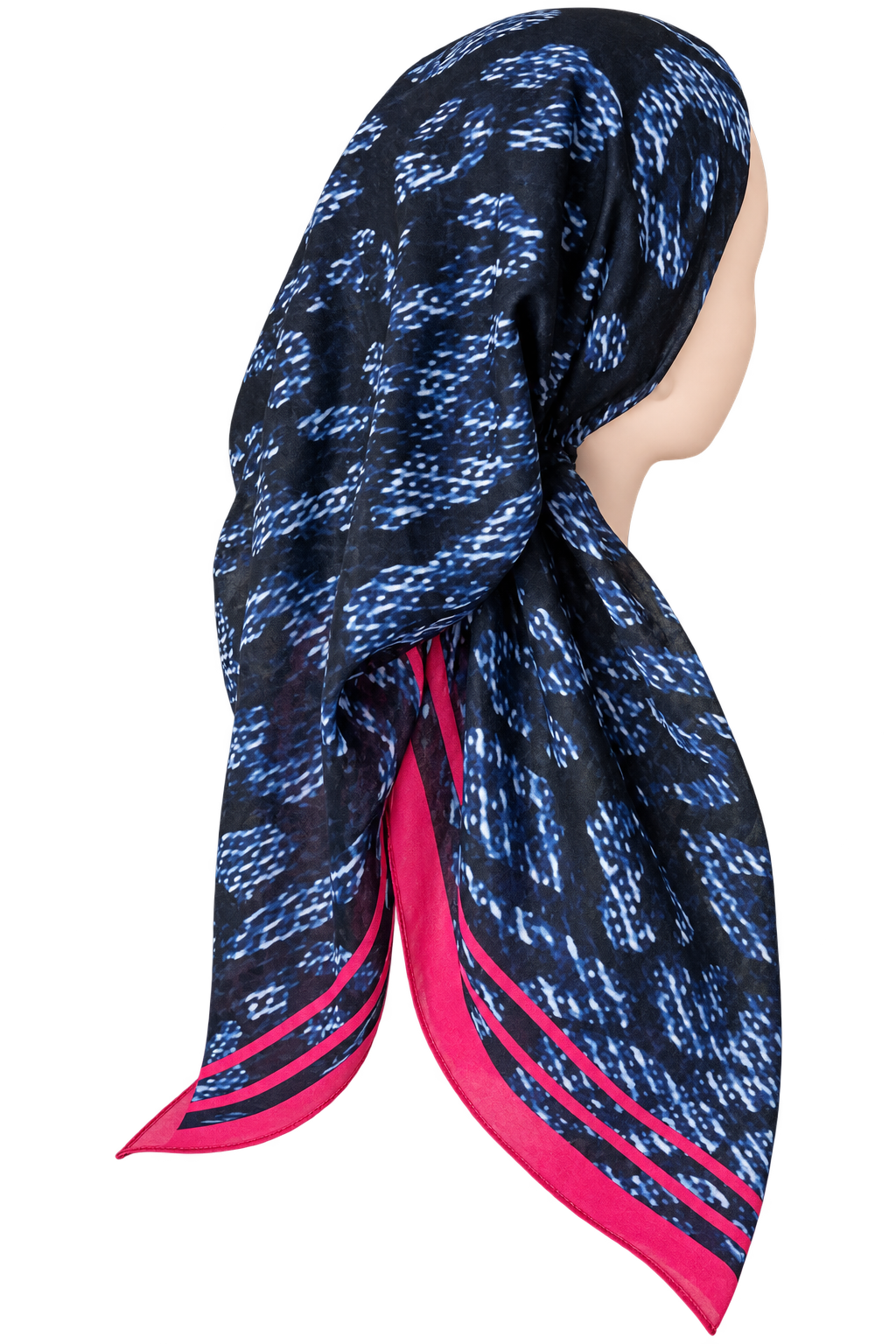A patterned square scarf displayed on a mannequin head, featuring a black base with blue abstract ikat-like motifs and bright pink border stripes.