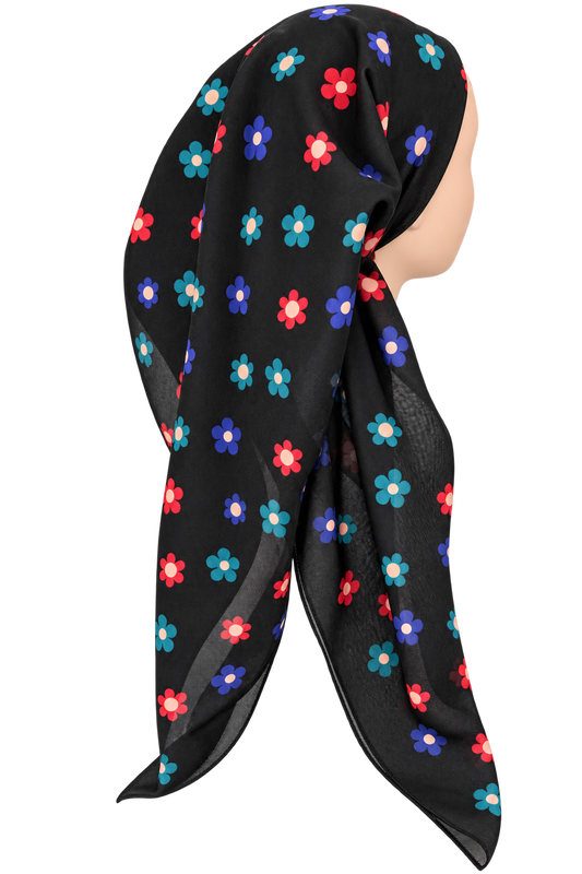 A black pretied tichel with a colorful floral pattern of red, blue, and teal flowers, displayed on a mannequin head against a white background.
