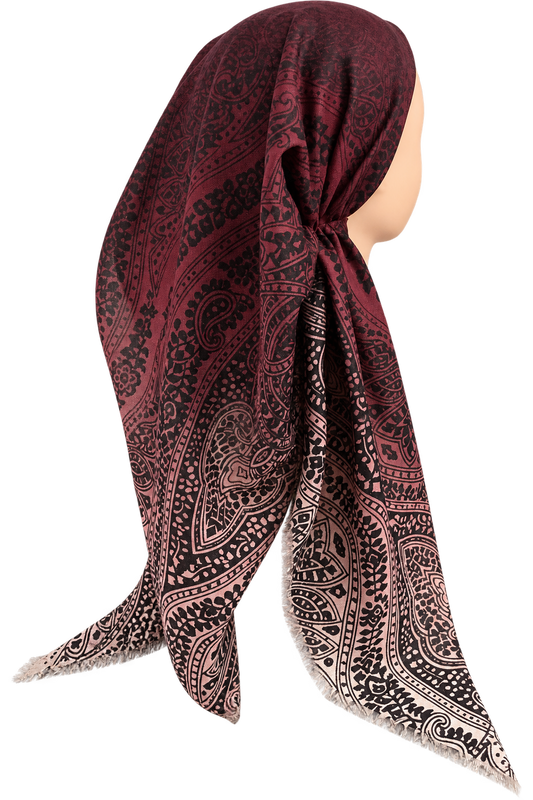 A square tichel scarf with a paisley pattern, draped on a mannequin head against a solid white background.