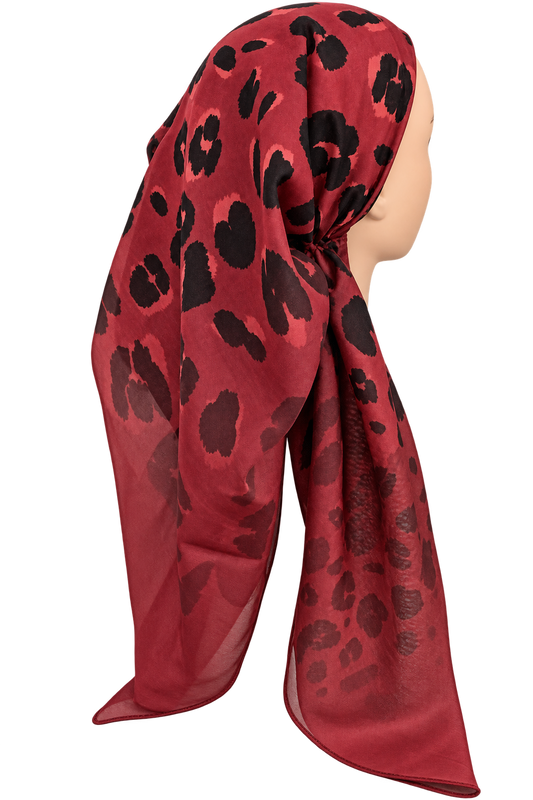 A red TICHEL with a black leopard print pattern, styled on a mannequin head against a plain white background.