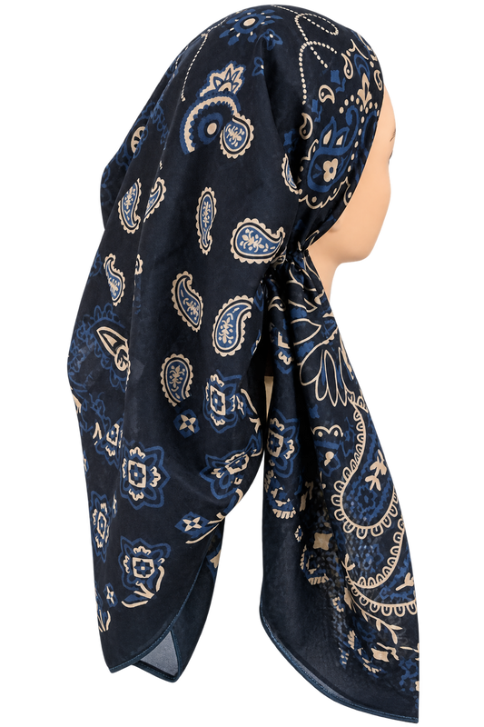 A navy blue headscarf with a beige and light blue paisley pattern, styled on a mannequin head against a plain white background.