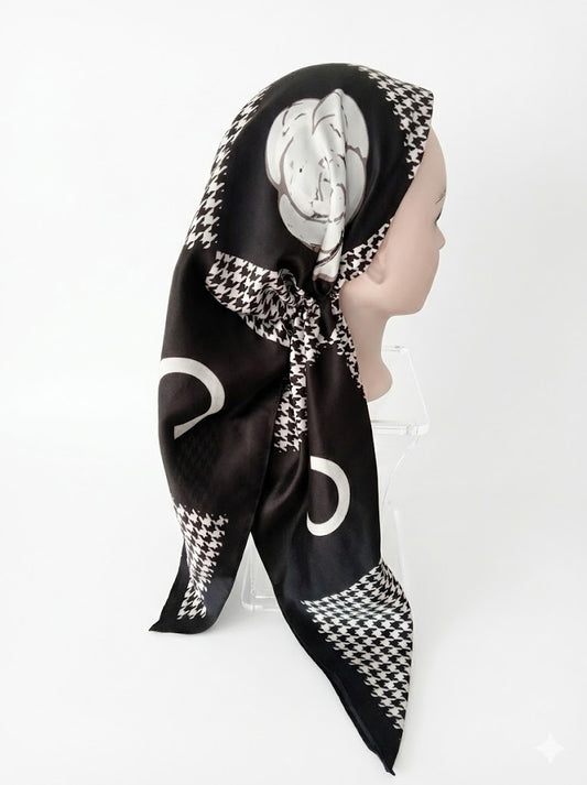 Black and white patterned pretied tichel on a mannequin head against a white background