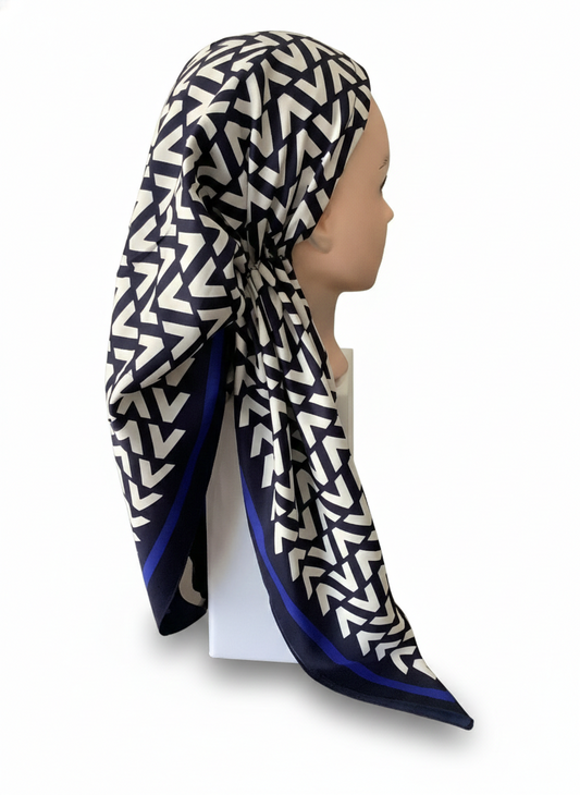 Mannequin wearing a patterned tichel with a white background