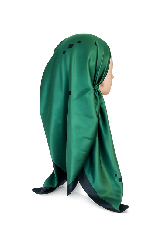 Green headscarf on a mannequin head against a white background