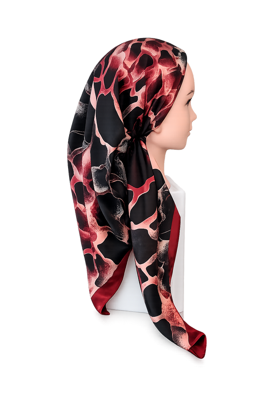 Mannequin head wearing a patterned pretied tichel on a white background