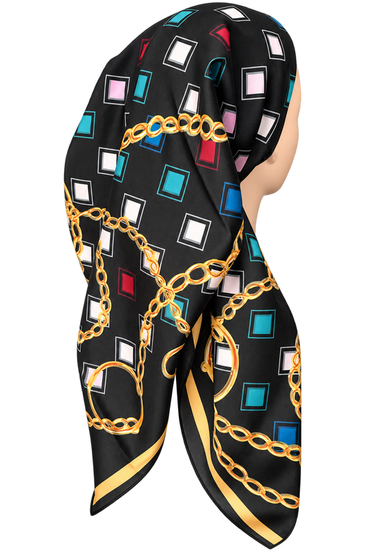 A black square scarf with a geometric print of colorful squares and gold chain motifs, styled on a mannequin head against a plain white background.