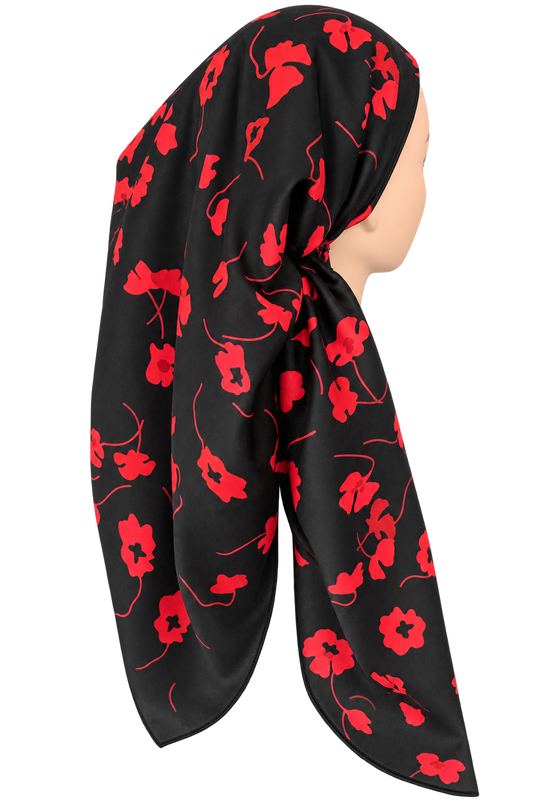 A black satin-like tichel with a vibrant red poppy floral pattern, styled on a mannequin head against a plain white background.
