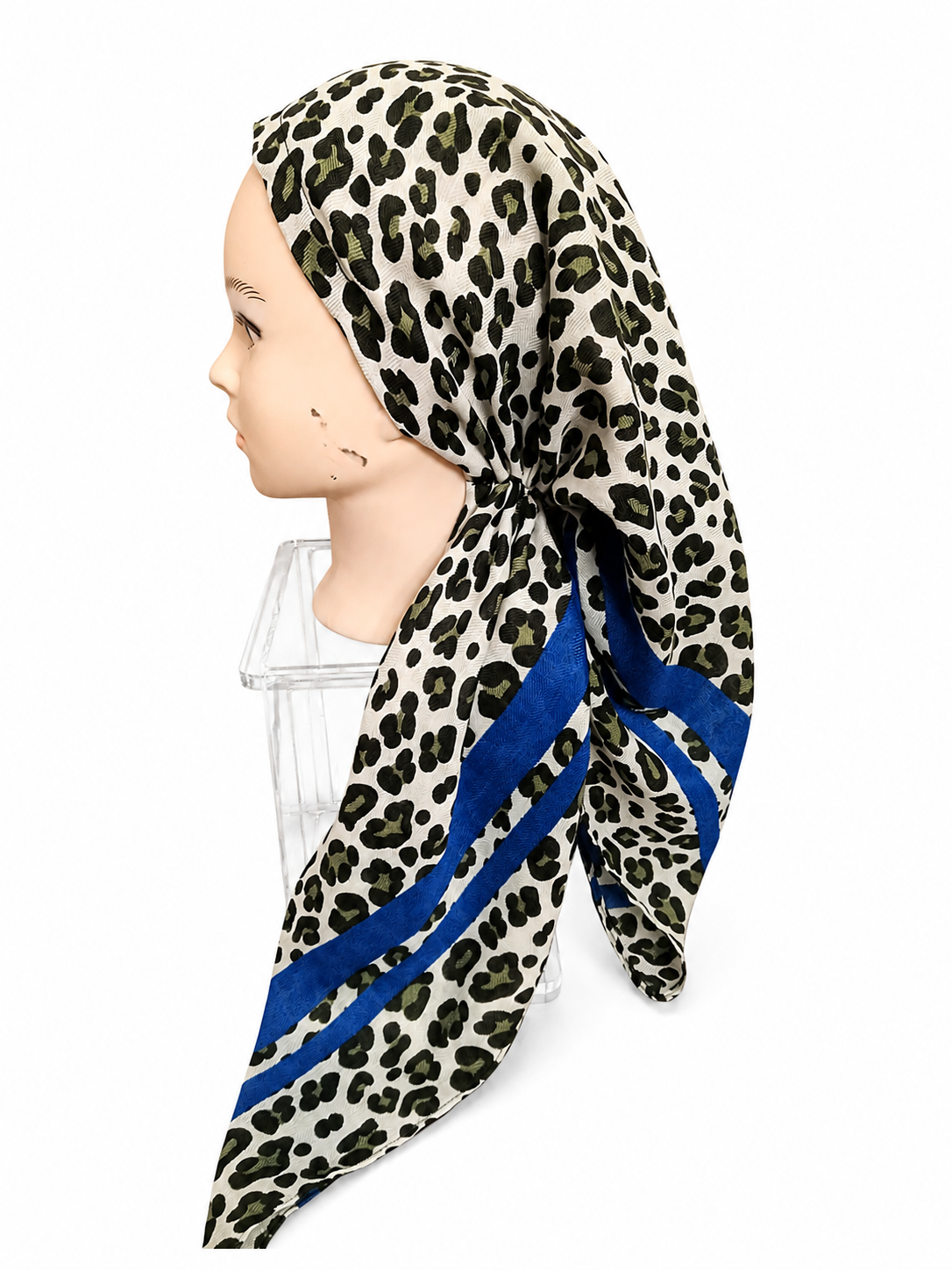 A leopard print scarf with royal blue stripes, displayed on a mannequin head against a plain white background.