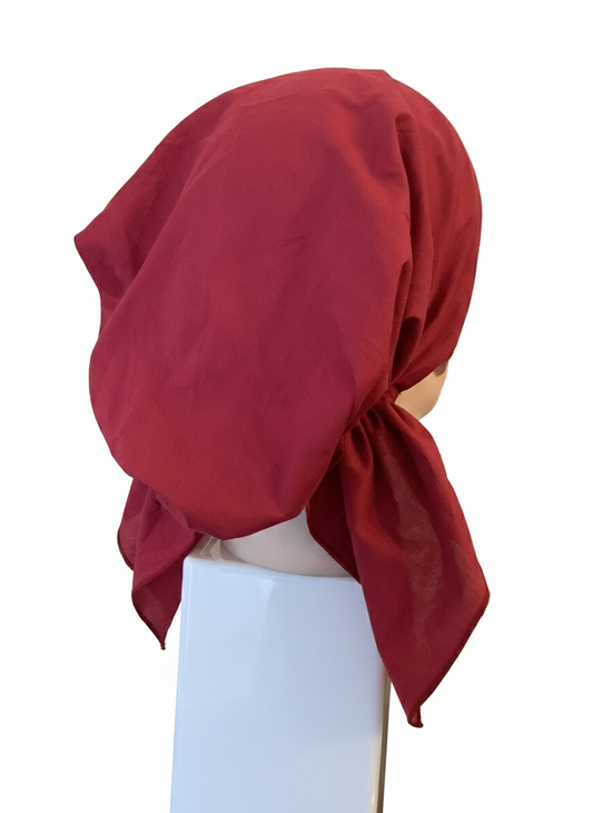 Red headscarf on a mannequin against a white background