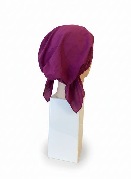 Purple headscarf on a mannequin head against a white background