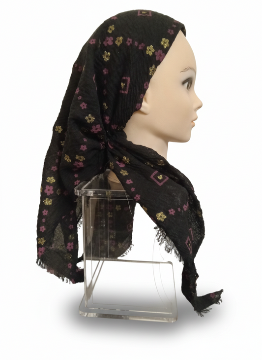 Black TICHEL with floral patterns on a mannequin head against a white background