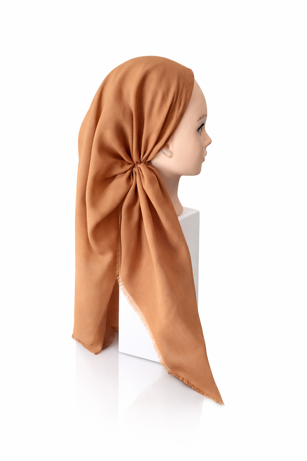 Mannequin head wearing a brown tichel on a white background