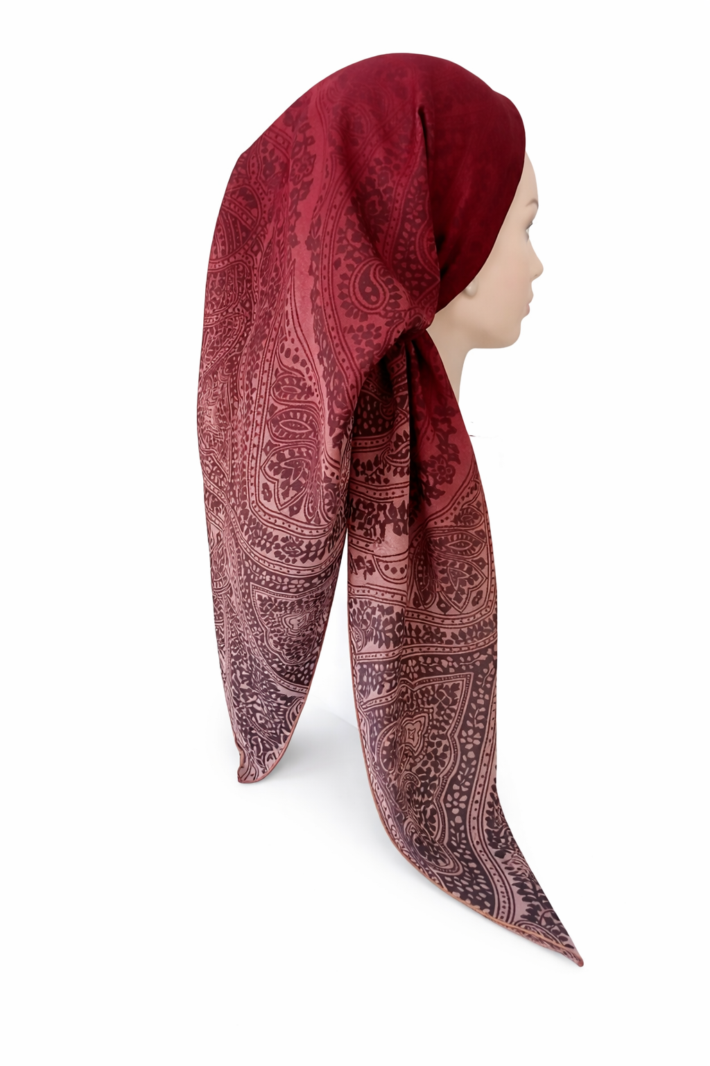 Red patterned headscarf on a mannequin head against a white background