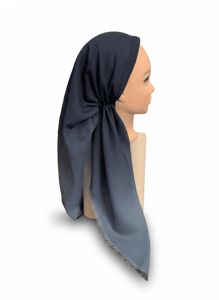 Mannequin head wearing a dark blue tichel on a white background